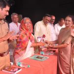 Dean felicitating Sarchitnis madam and chief guest looks on
